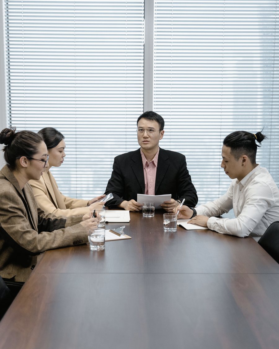 A board meeting reviewing company documents